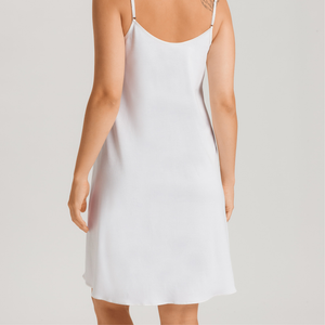 White slip dress worn by a person on a plain background