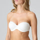 White strapless bra worn by a model on a gray background