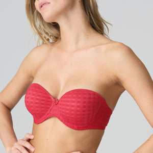 Red strapless bra worn by a model on a gray background