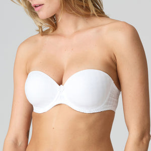 White strapless bra worn by a model on a plain background
