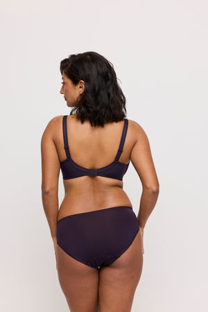 Woman wearing a dark purple set on a white background